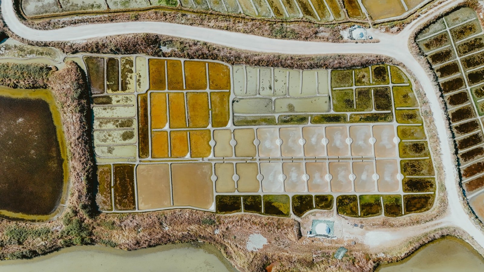 Aerial view of colorful salt evaporation ponds used to extract lithium from brine
