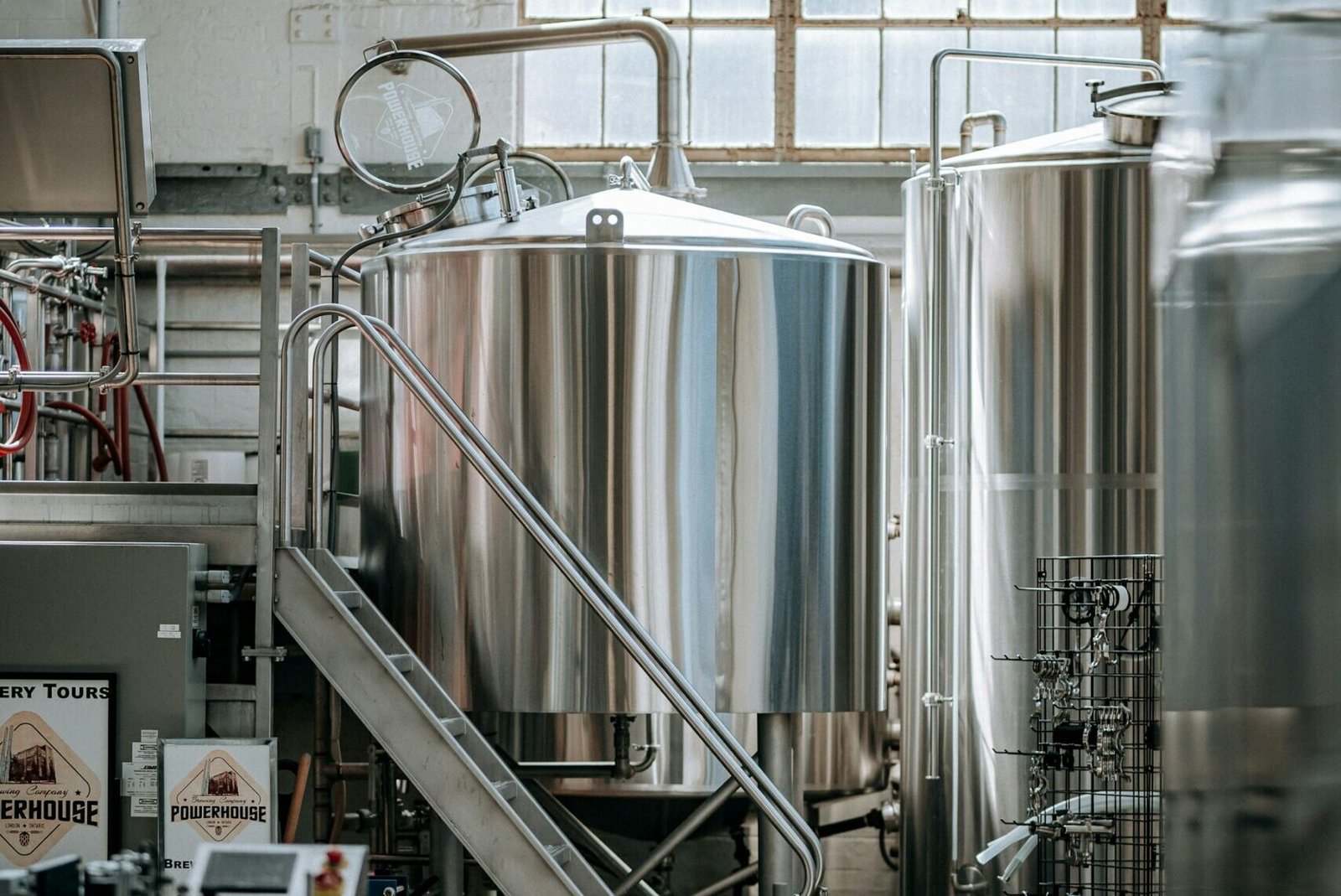 Industrial hall with rows of stainless steel process tanks